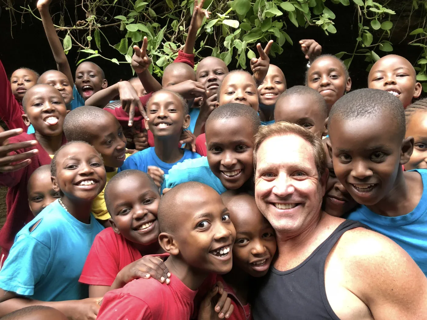 Troy Wiseman surrounded by children at one of the orphanages he founded and supported