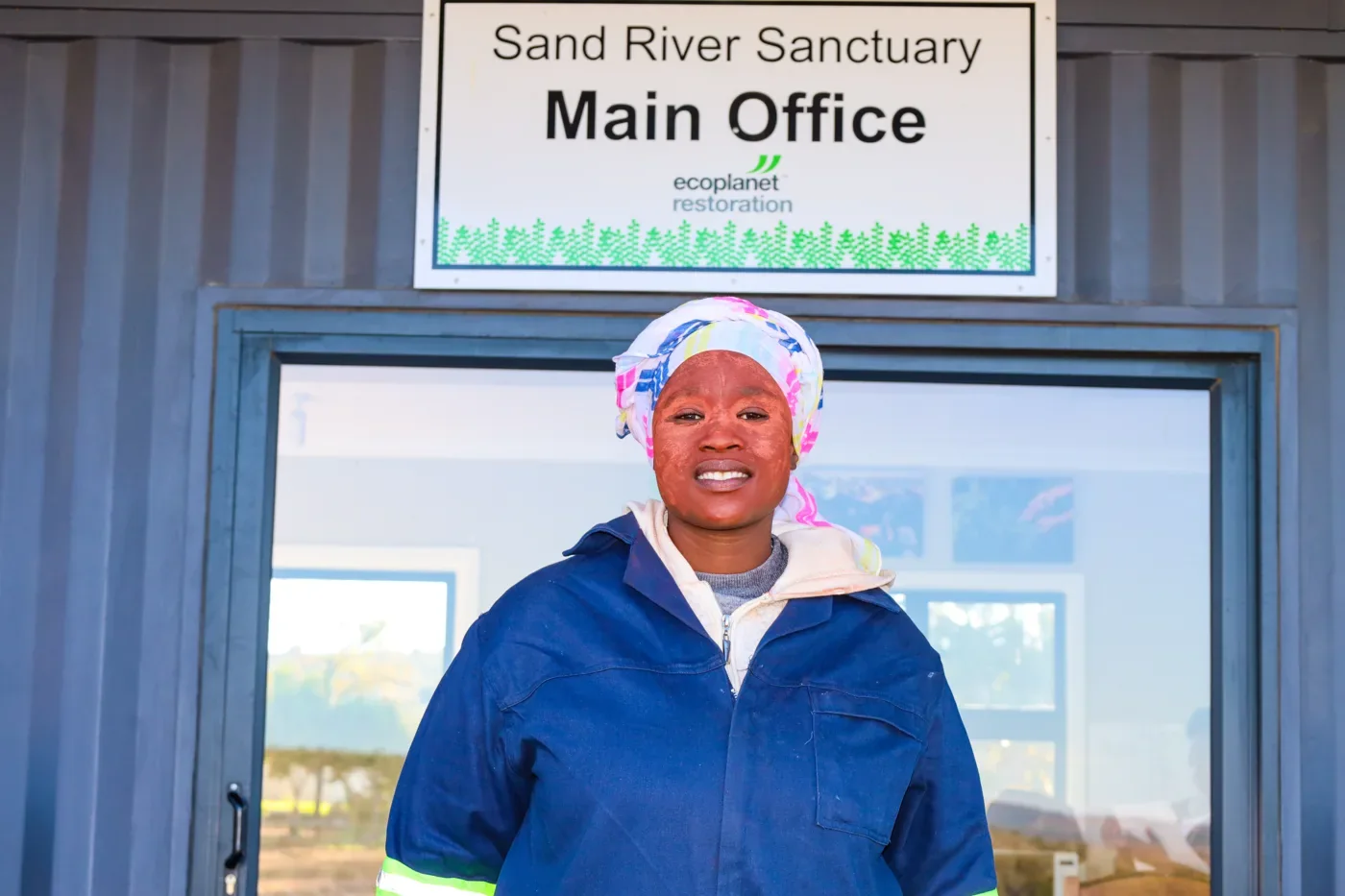A worker outside the Sand River Sanctuary office, South Africa