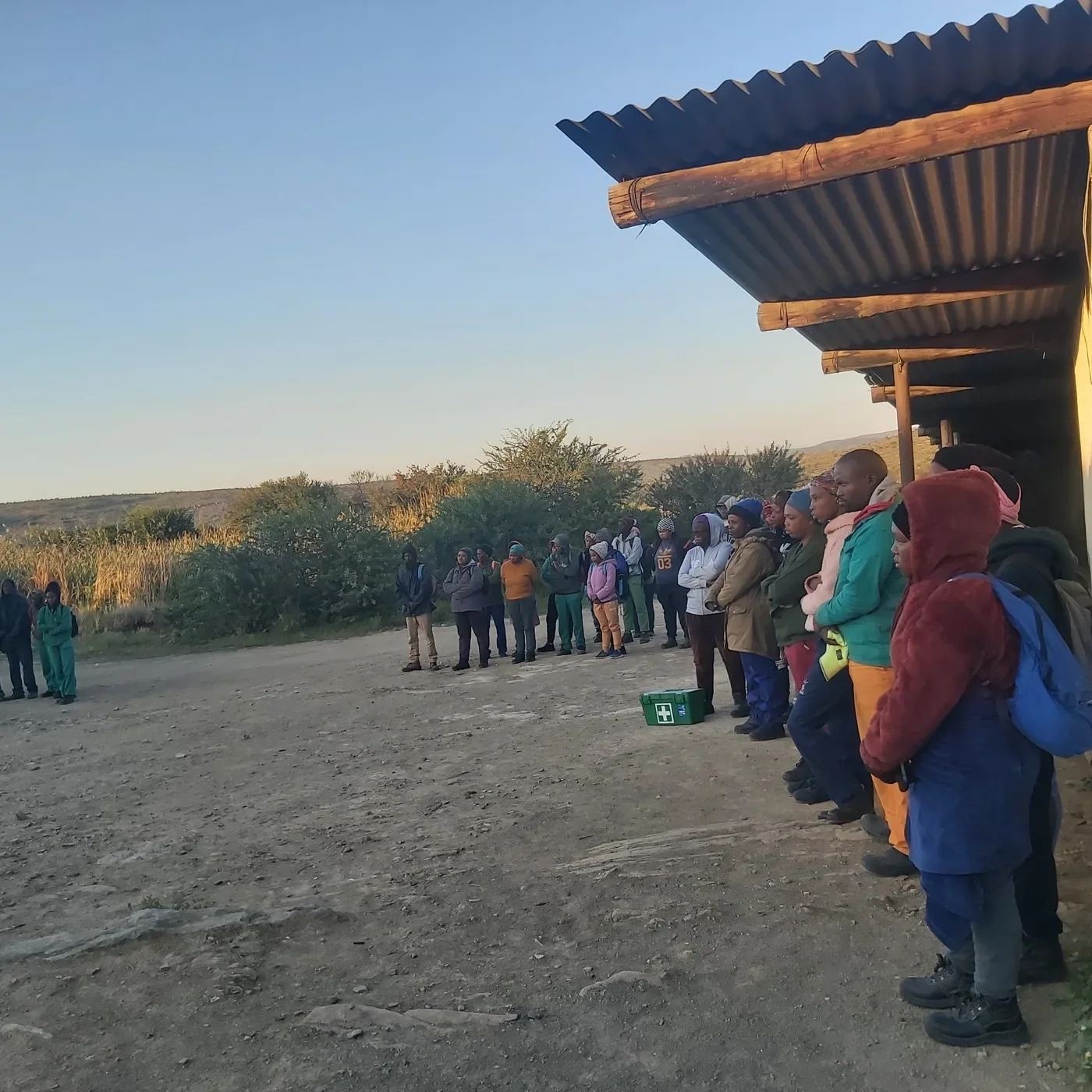 Workers lined up for a sunrise safety briefing before a day of planting, Eastern Cape